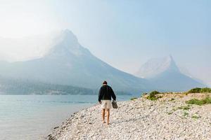 Man walking along shore in Montana photo