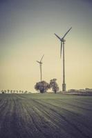 Wind turbines silhouette in the meadow
