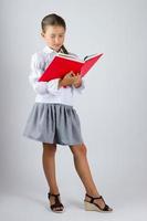 Smart schoolgirl reading a book