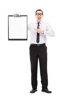 Happy business guy pointing on a clipboard photo