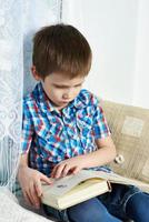Little boy reading book photo