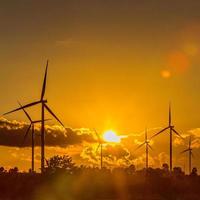 Wind turbine power generator silhouette at sunset photo