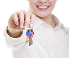 Woman real estate agent holding set keys to new house