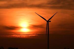Wind turbines silhouette at sunset photo