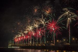 Fireworks by water at night photo