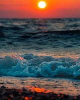 Ocean wave foam on brown sand photo