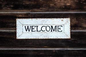 Black and white wooden welcome sign photo