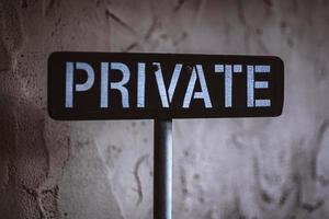 Private sign on white wall photo