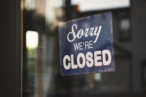 Sorry we're closed sign on glass door photo