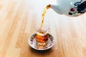 Pouring tea into cup photo
