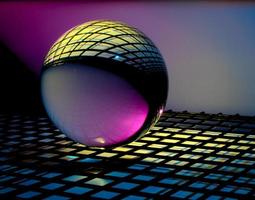 Glass ball on colorful surface