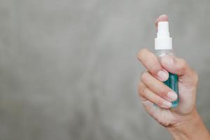 Close-up of hand spraying disinfectant photo