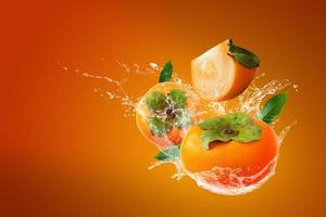 Water splashing on fresh persimmons  photo
