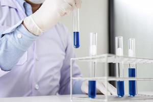 Scientist holding test tube  photo