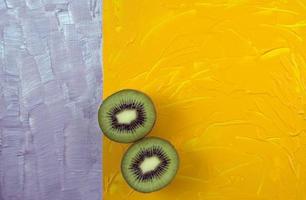 Top view of sliced kiwi on colorful surface photo