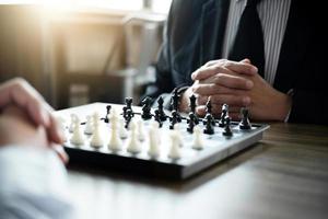 Colleagues playing chess game  photo