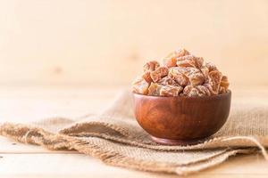 Dried plums in a bowl photo