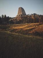 Devil's Tower surrounded by trees photo