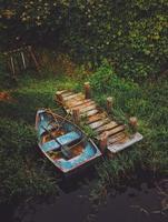 Blue and brown canoe beside dock photo