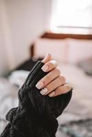 Close-up of hand with decorative nails photo