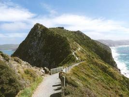 Walking path through green mountain photo