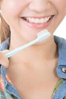 Closeup shot of asian woman brushing teeth