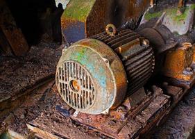 Old electric motor in abandoned factory photo