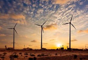 Wind generator turbines sihouettes on sunset