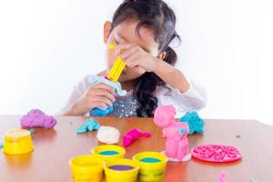 Little girl play colorful dough