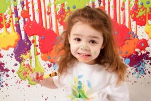 Little girl playing with paint photo