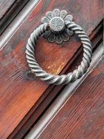 Vintage doorknob on antique door, background
