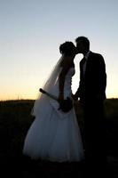 Bride and groom kissing photo