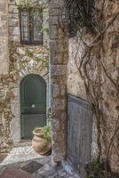 Green front door in a stone house in the Mediterranean