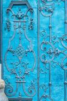 Close up of blue painted richly decorated baroque steel door photo