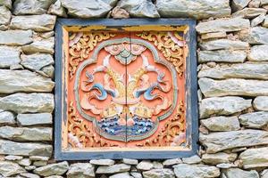 Traditional decorated window on stone Tibet house photo