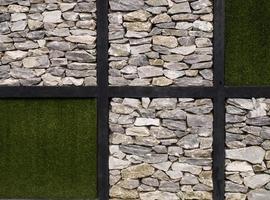 Artificial grass  and stone wall as background photo