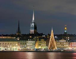 Skyline at night in Stockholm with lit up Christmas tree photo