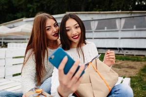 Two girls make selfie with gifts
