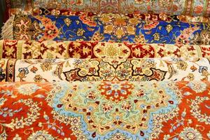 Many vibrant multicolored Persian carpets photo