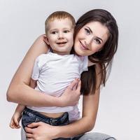 happy mother with a child on light grey background