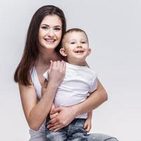happy mother with a child on light grey background photo