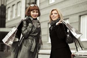 Two young fashion women with shopping bags photo