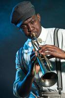 Black african american jazz trumpet player. Vintage. Studio shot. photo