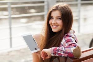 Face portrait of young woman using a tablet pc photo