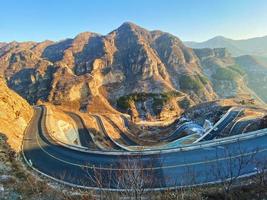 View of mountain road leading to a valley  photo