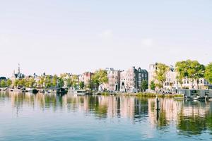 Row of buildings next to body of water photo