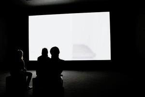 People looking at projection screen photo