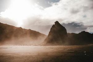 Mountains in fog and cloudy sky photo