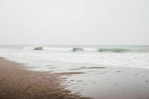 Person surfing on waves photo