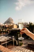 Person holding glass of white wine photo